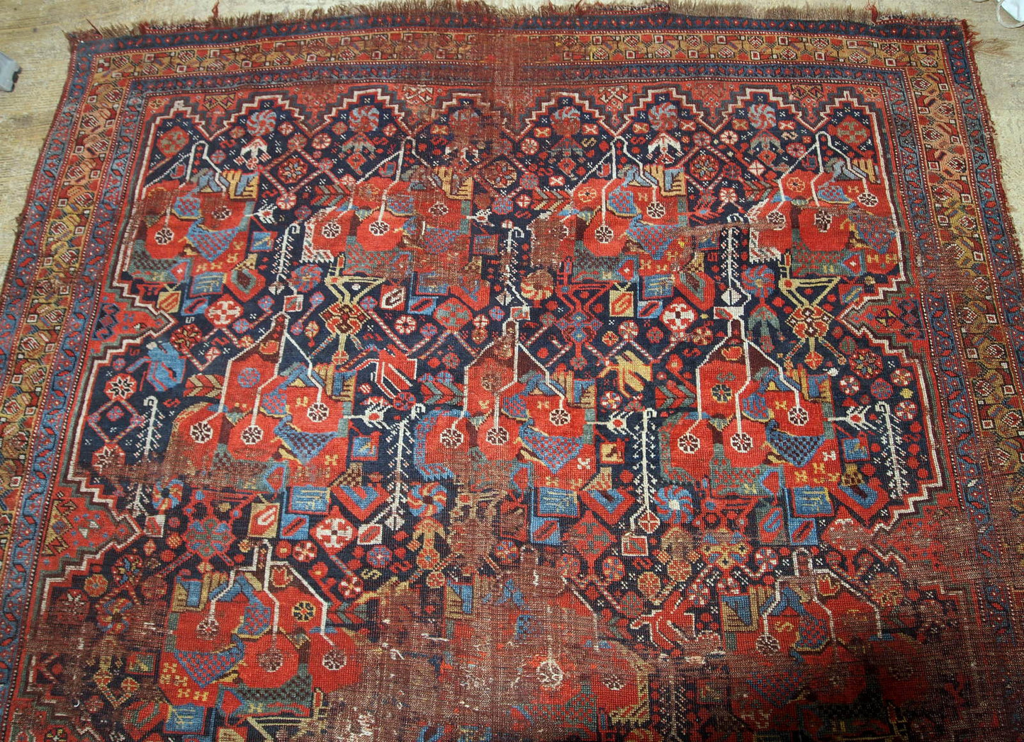 Antique handmade collectible Khamseh rug from the mid-18th century. It is in bright natural colours and in distressed condition.