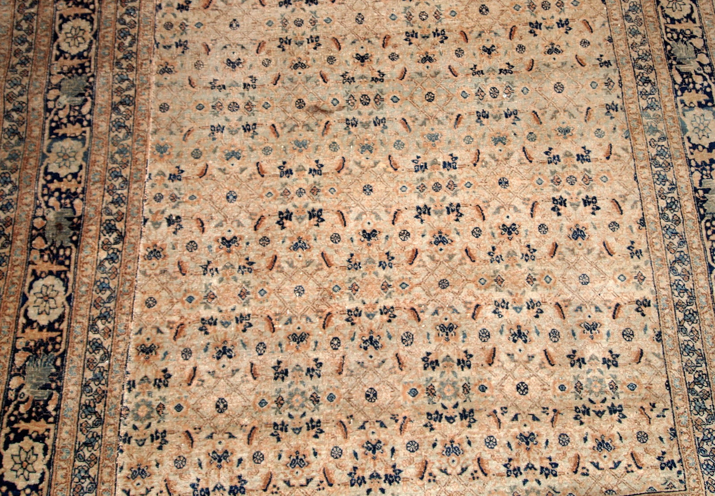Antique Persian Tabriz Hajalili rug in beige, brown and blue wool. The rug is from the end of 19th century, it has one cut.