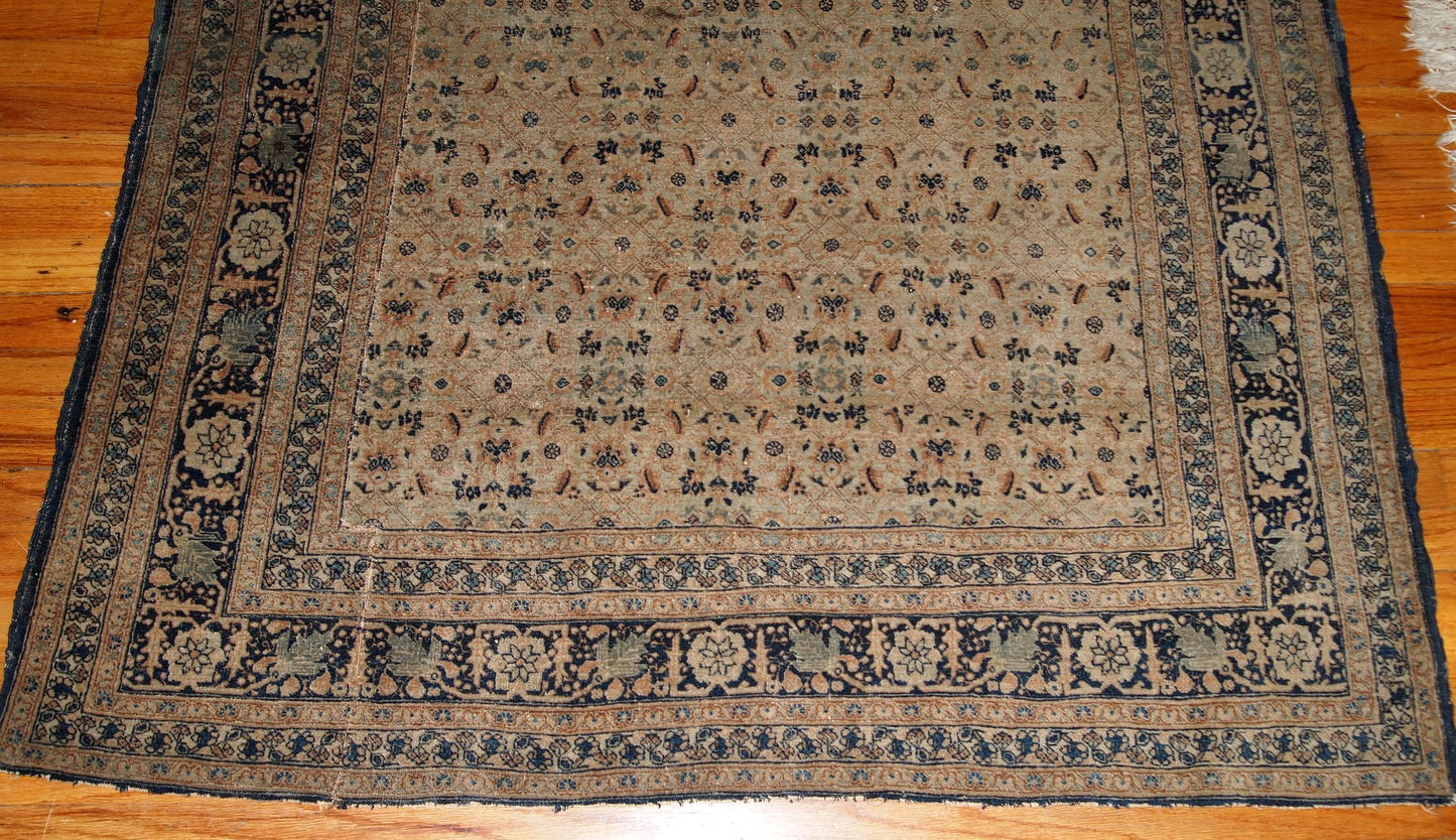 Antique Persian Tabriz Hajalili rug in beige, brown and blue wool. The rug is from the end of 19th century, it has one cut.