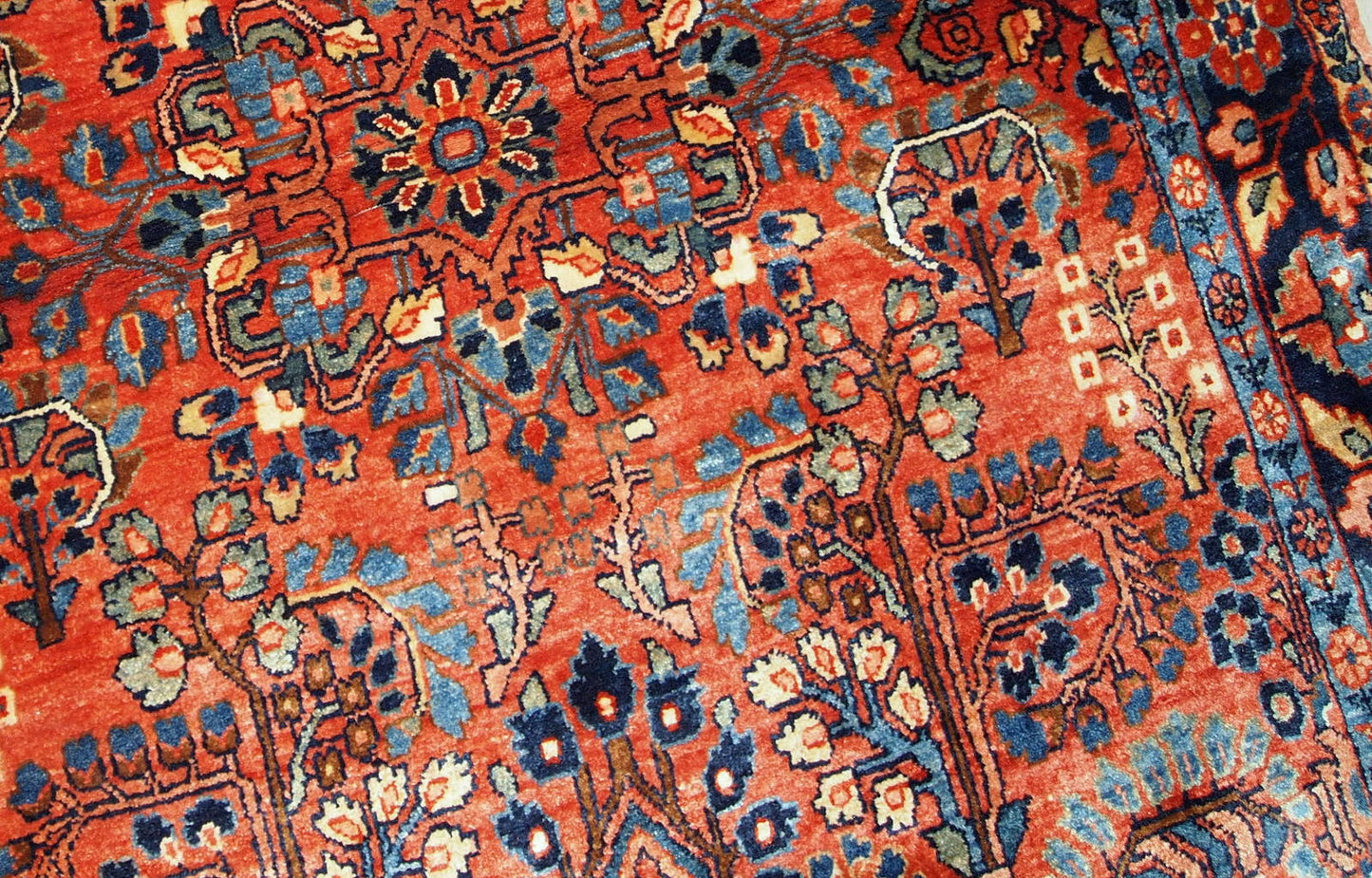 This antique Persian Sarouk rug made in the beginning of 20th century in red wool. The rug is in original good condition.
