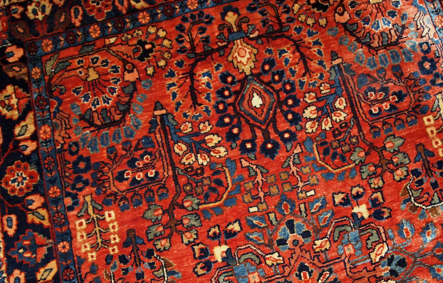 This antique Persian Sarouk rug made in the beginning of 20th century in red wool. The rug is in original good condition.