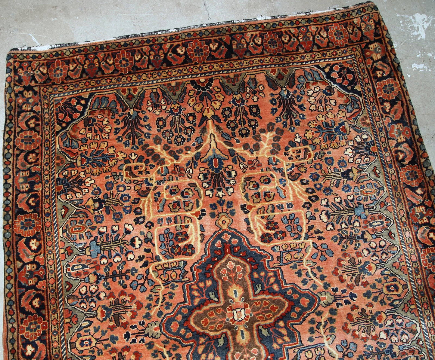 Antique hand made Persian Sarouk rug in peach shades. The rug is from the beginning of 20th century in original good condition.