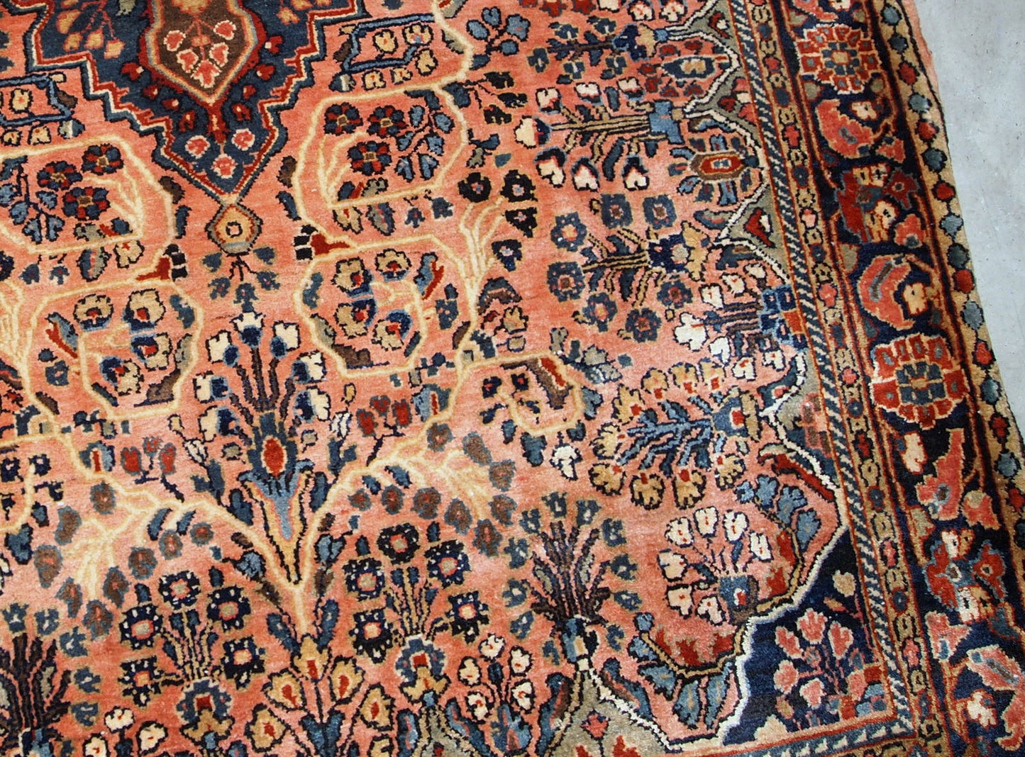 Antique hand made Persian Sarouk rug in peach shades. The rug is from the beginning of 20th century in original good condition.