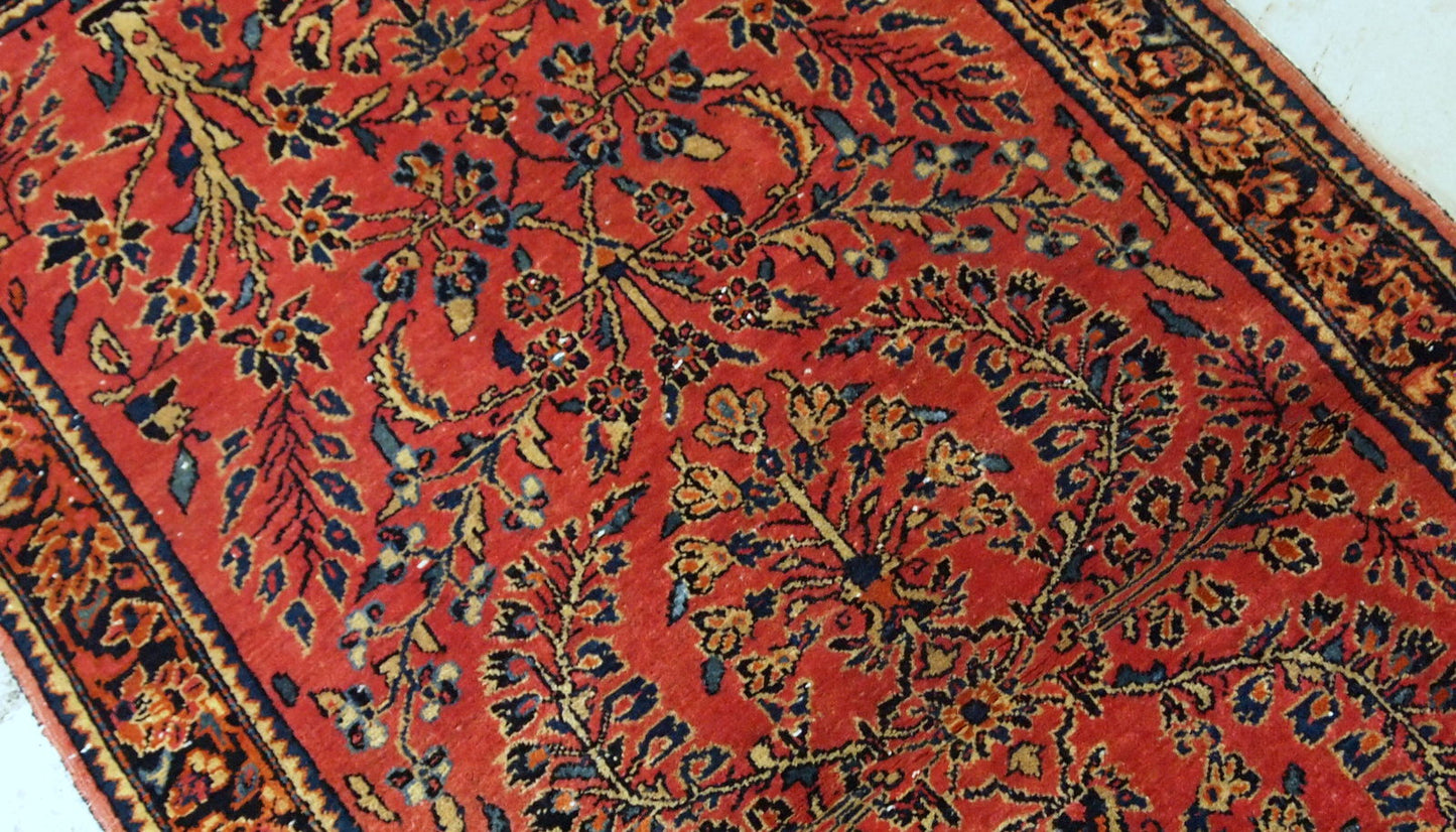 Antique hand made Persian Sarouk runner in red wool and floral design. The rug made in 1900s and it is in original good condition.