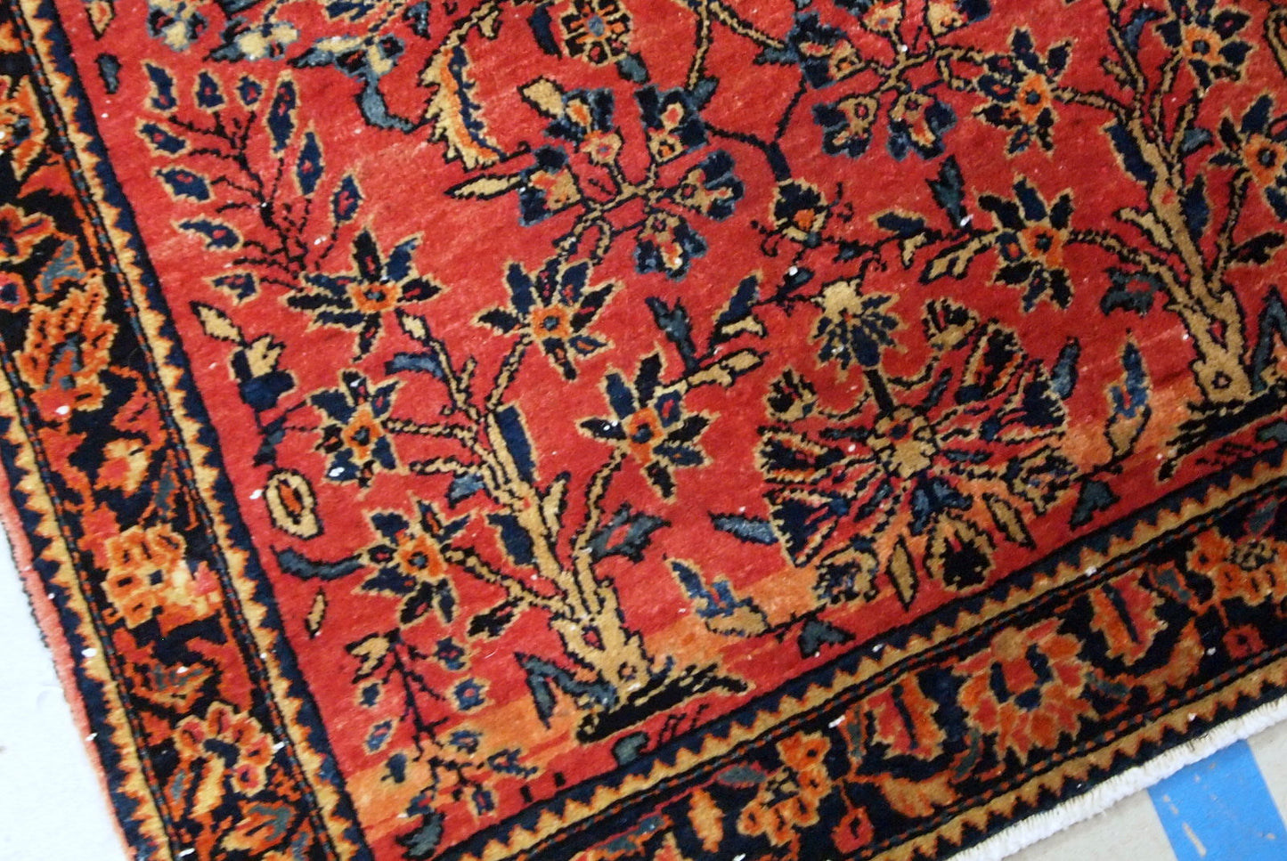Antique hand made Persian Sarouk runner in red wool and floral design. The rug made in 1900s and it is in original good condition.