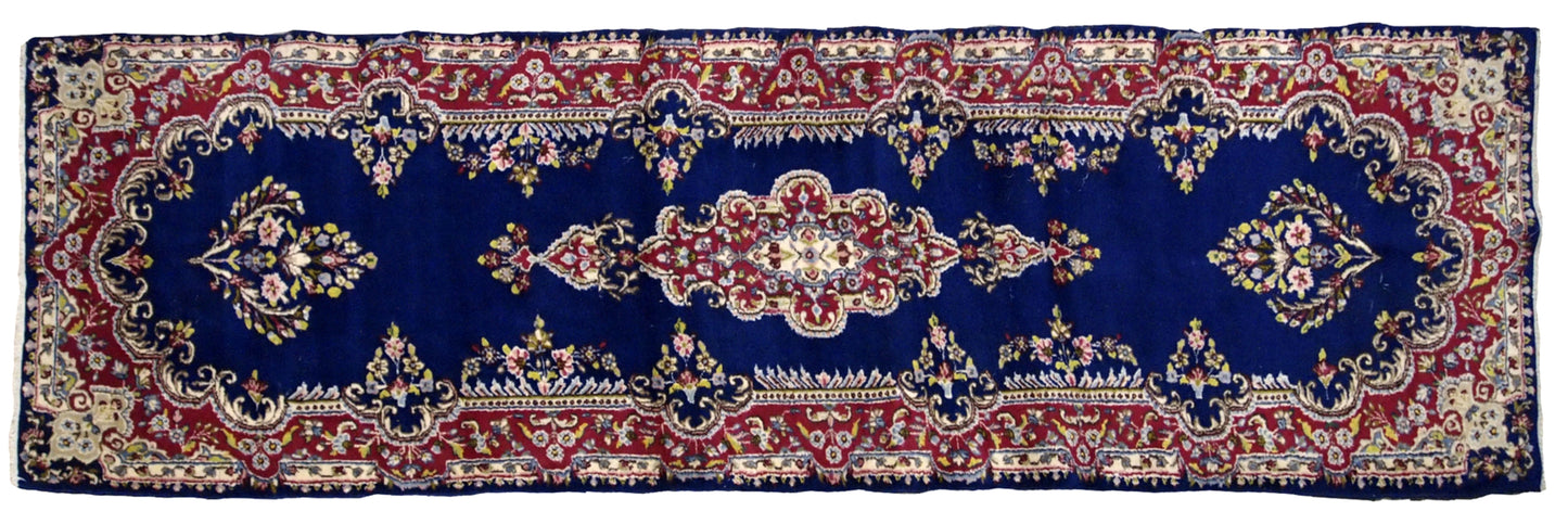 Handmade antique Persian Kerman runner in bright blue and red wool. The runner is from the middle of 20th century in original good condition.