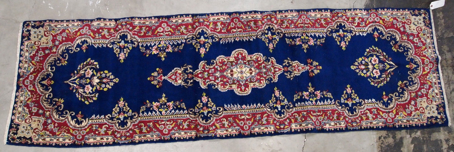 Handmade antique Persian Kerman runner in bright blue and red wool. The runner is from the middle of 20th century in original good condition.