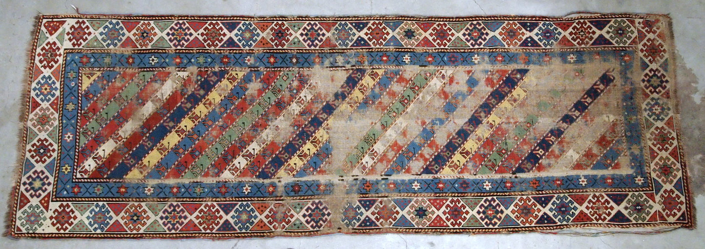 Handmade antique Caucasian rug in distressed condition, from the end of 19th century.