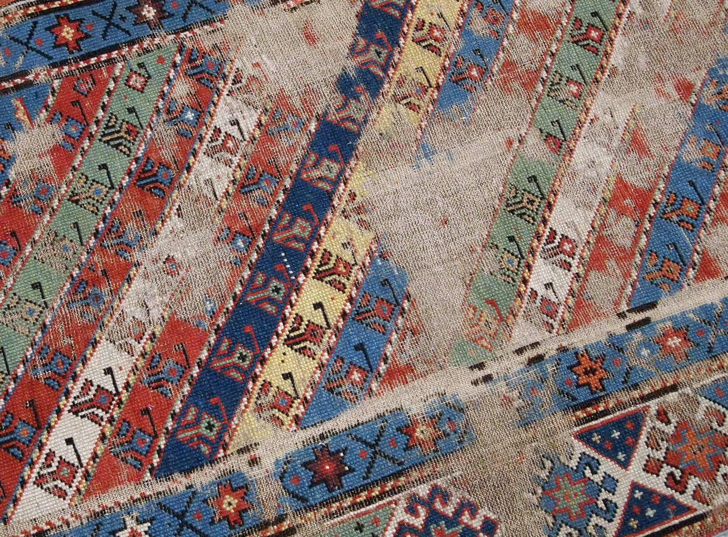 Handmade antique Caucasian rug in distressed condition, from the end of 19th century. 