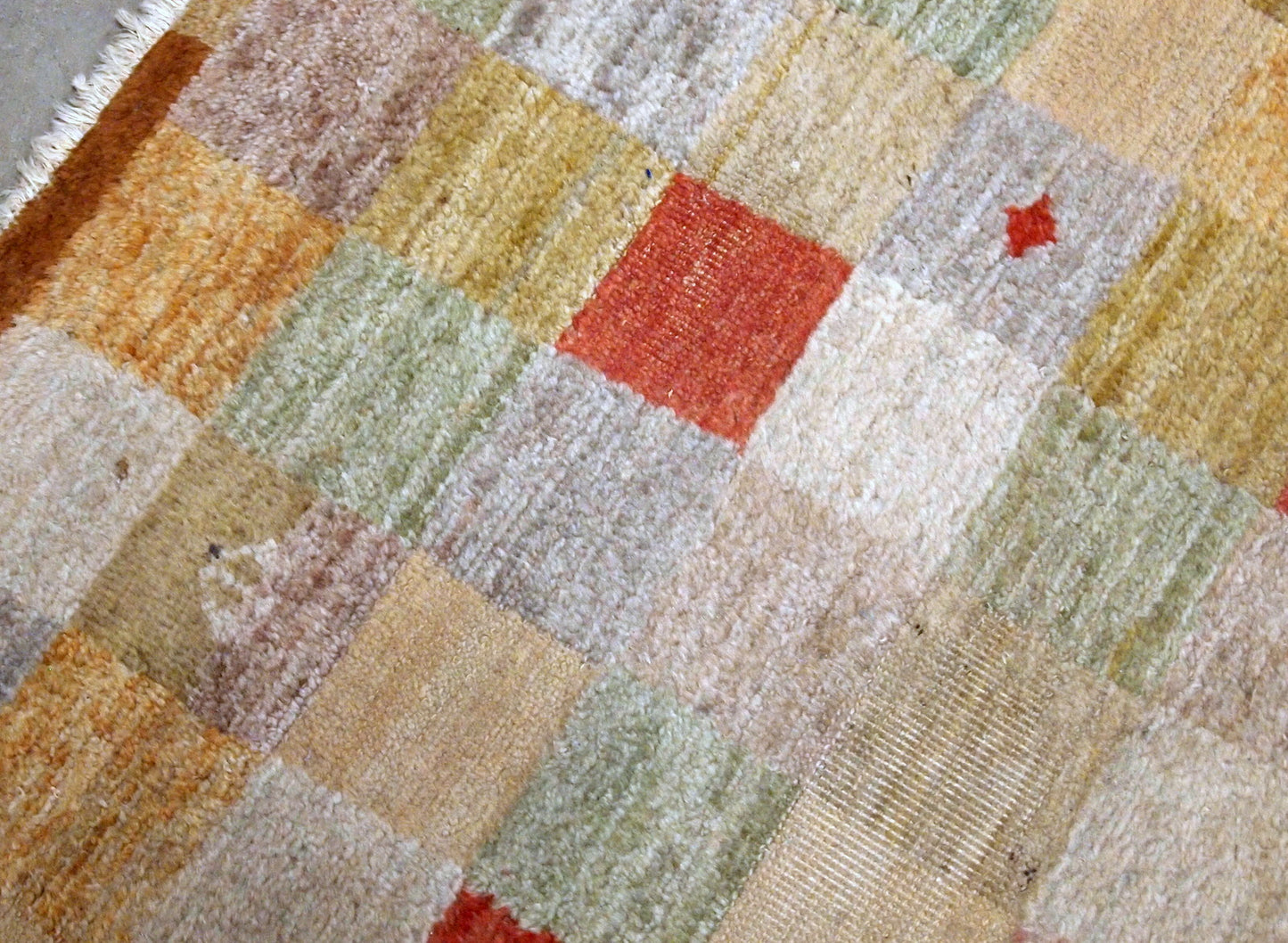 Vintage Chinese modern rug in colorful shades. The rug made in wool in the end of 20th century, it has some low pile due to age.