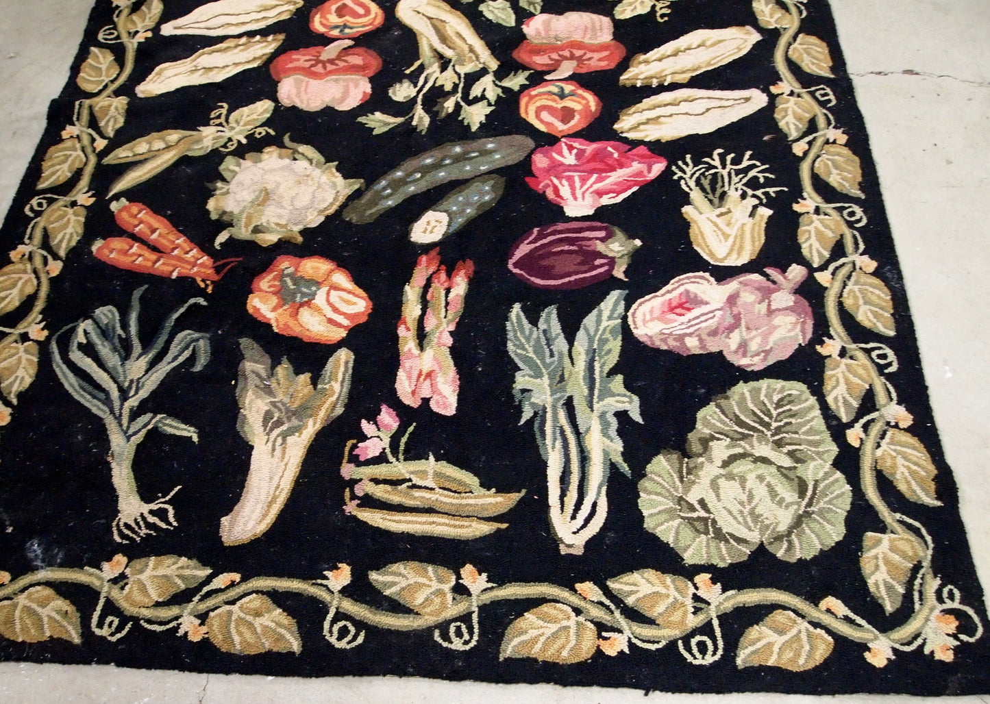 Handmade antique American Hooked rug in black color with variety of vegetables. This rug has been made in the beginning of 20th century, it remains in original good condition.
