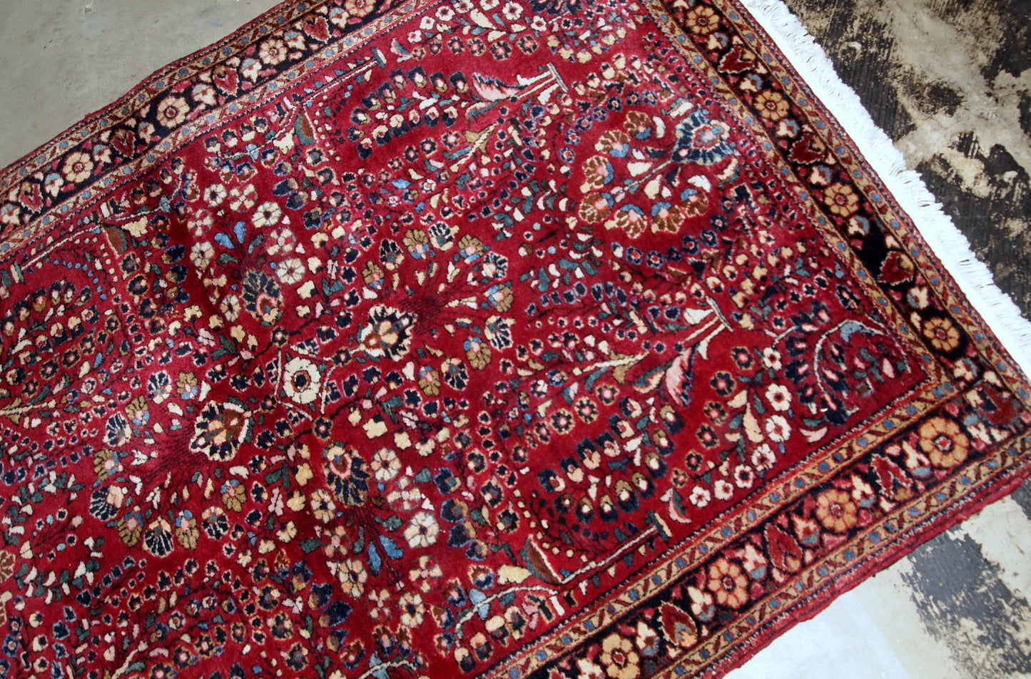 Handmade antique Sarouk rug in bright red colour. The rug is in original good condition from the beginning of 20th century.