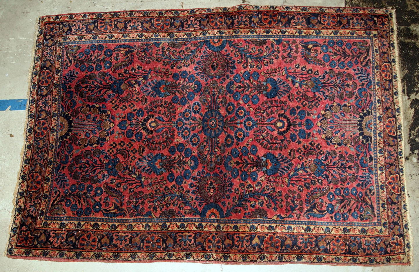 Handmade antique Sarouk rug in bright red and blue shades. The rug is in original good condition from the beginning of 20th century.