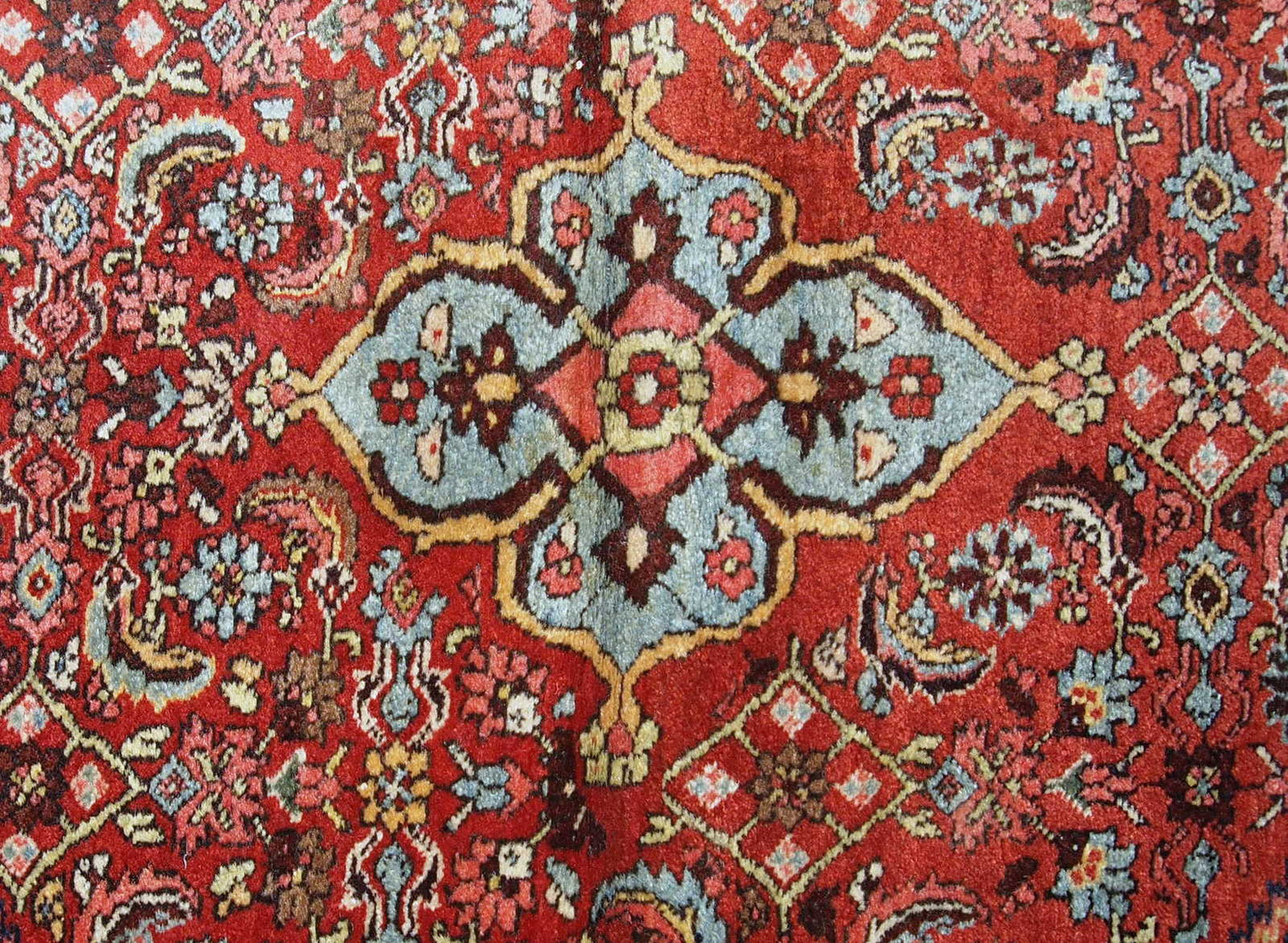 Handmade antique Bidjar rug from the beginning of 20th century. The rug is in original good condition made in red and blue wool.