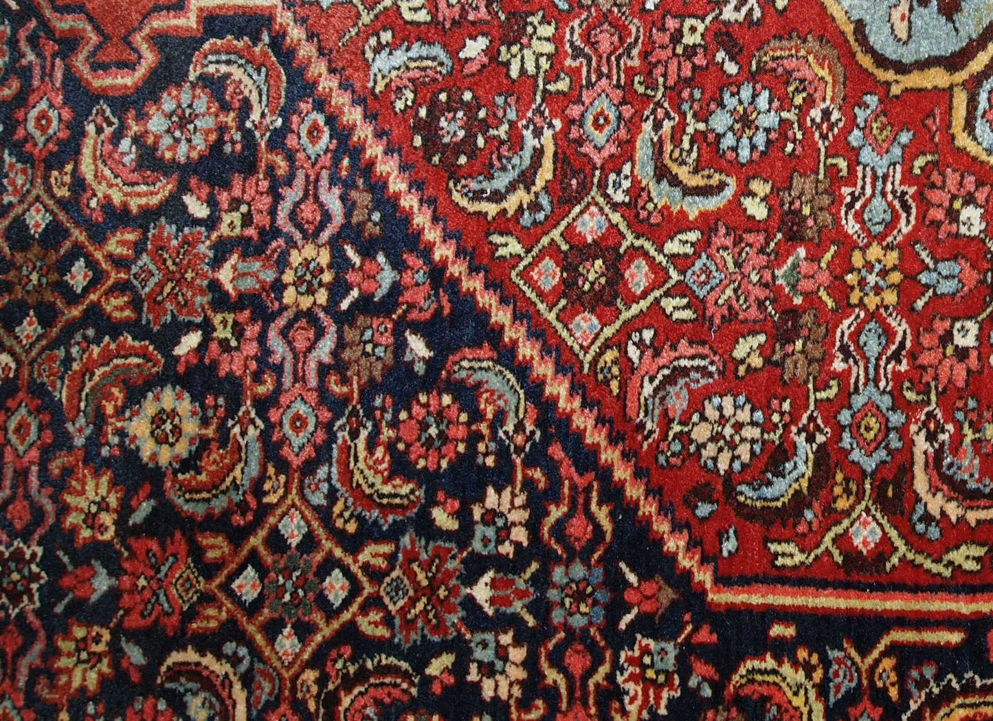 Handmade antique Bidjar rug from the beginning of 20th century. The rug is in original good condition made in red and blue wool.
