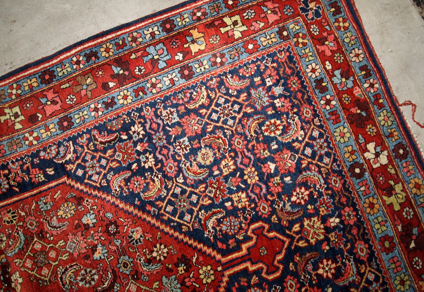 Handmade antique Bidjar rug from the beginning of 20th century. The rug is in original good condition made in red and blue wool.