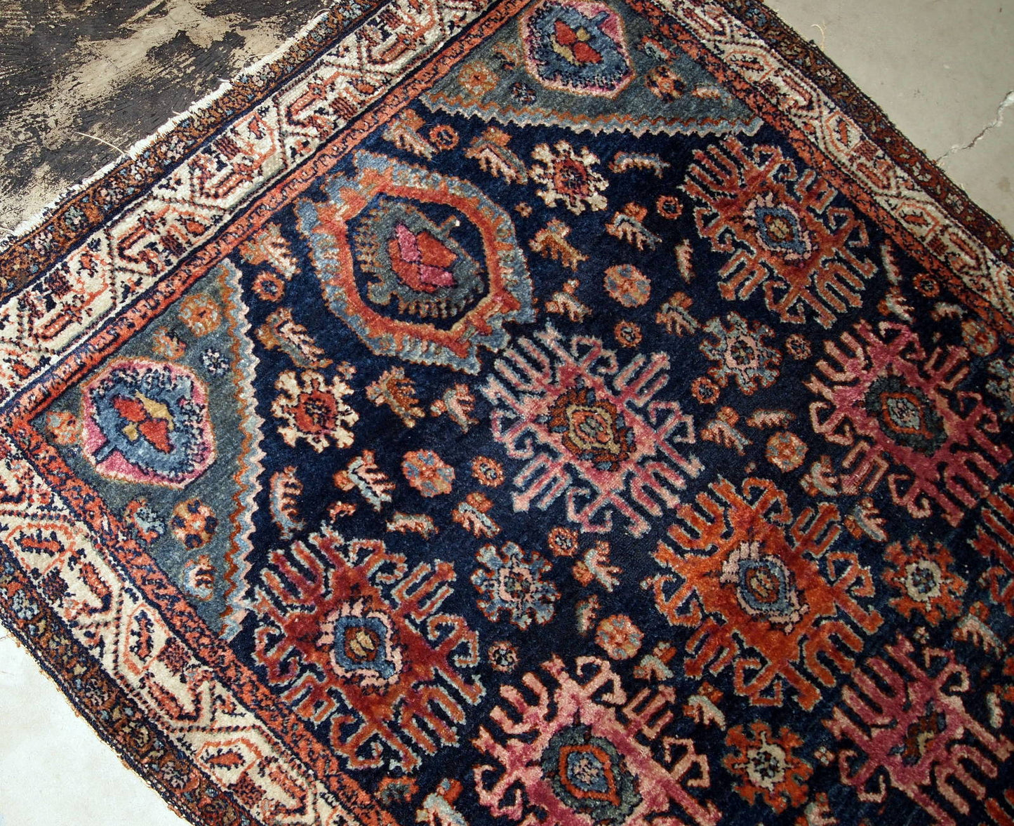 Handmade antique Malayer rug from the beginning of 20th century. The rug is in original good condition, has all-over design on navy blue background.