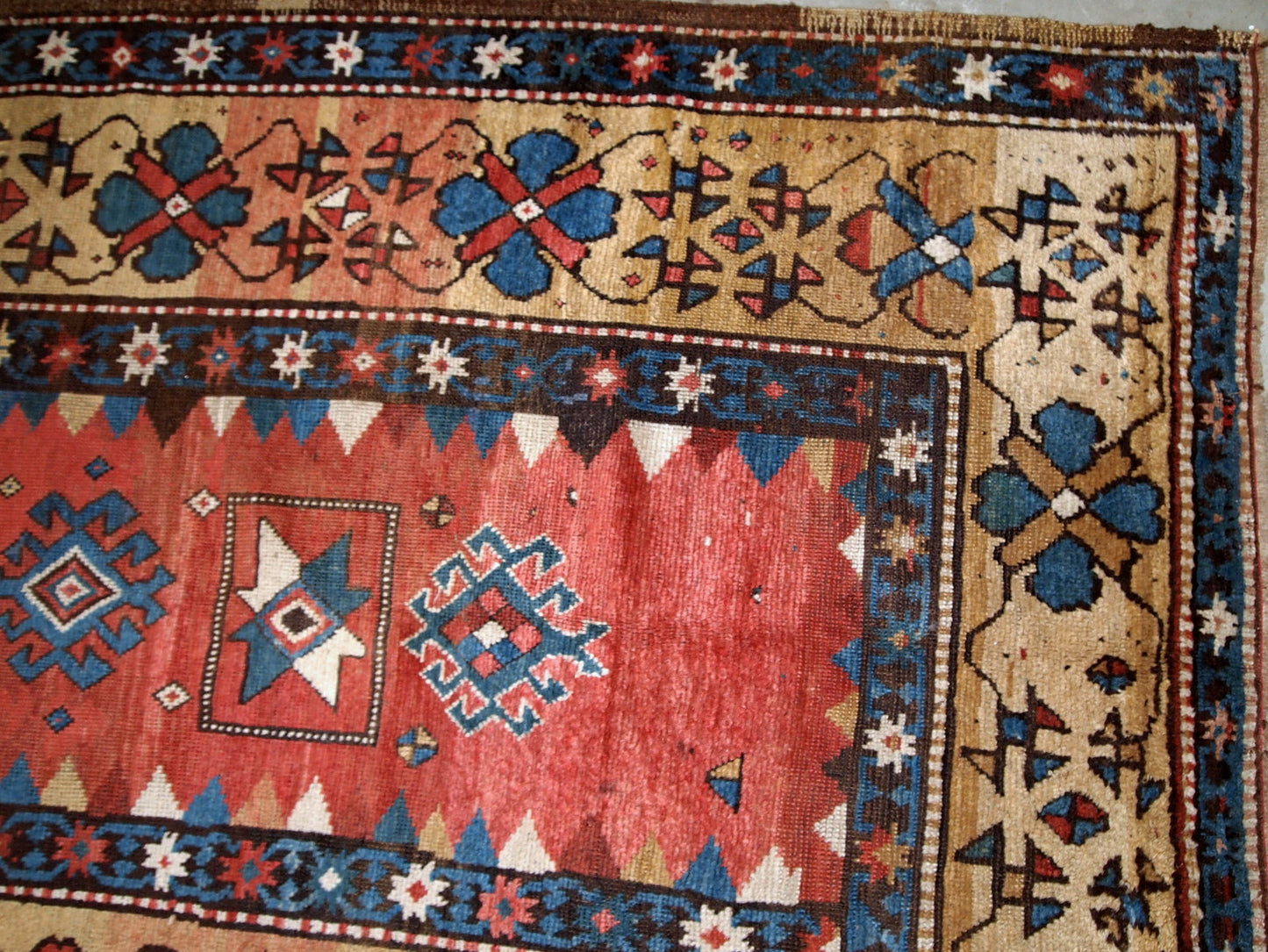 Handmade antique Caucasian Kazak rug in red and yellow shades. The rug is from the end of 19th century from Russia in original good condition.