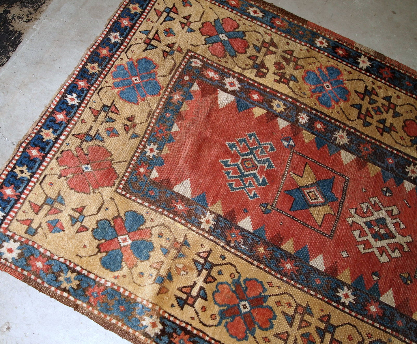 Handmade antique Caucasian Kazak rug in red and yellow shades. The rug is from the end of 19th century from Russia in original good condition.