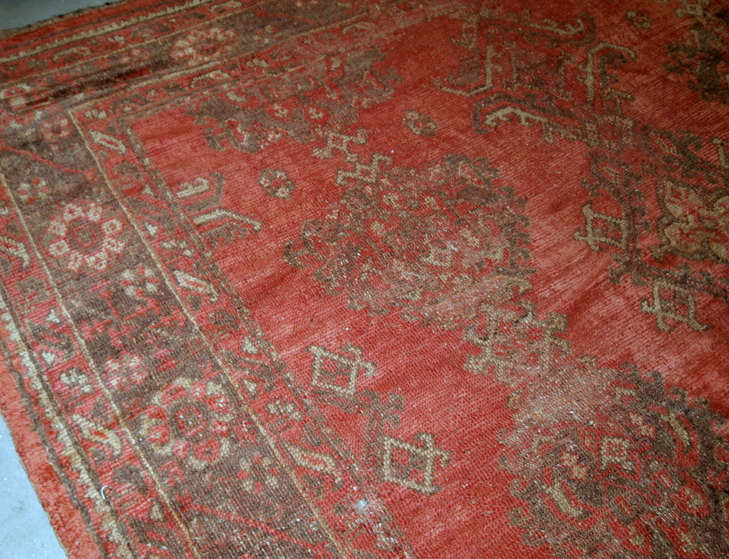 Antique handmade Turkish rug in orange color. The rug is from the beginning of 20th century in original condition, it has some signs of age.