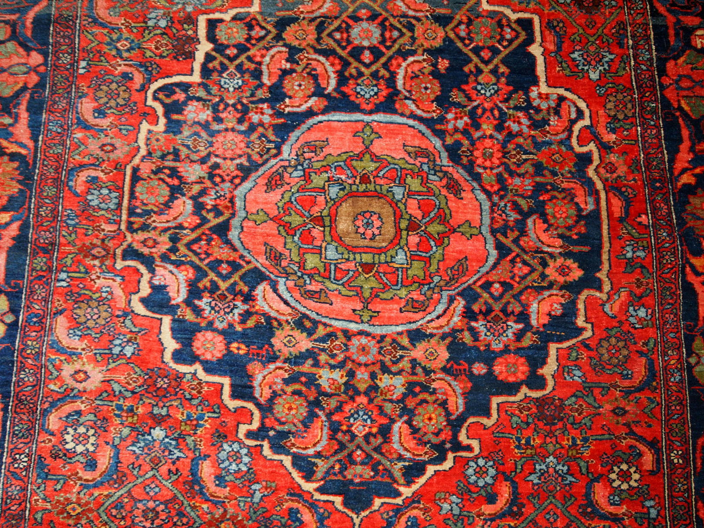 Handmade antique Bidjar rug from the beginning of 20th century. The rug is in original good condition made in bright red wool.