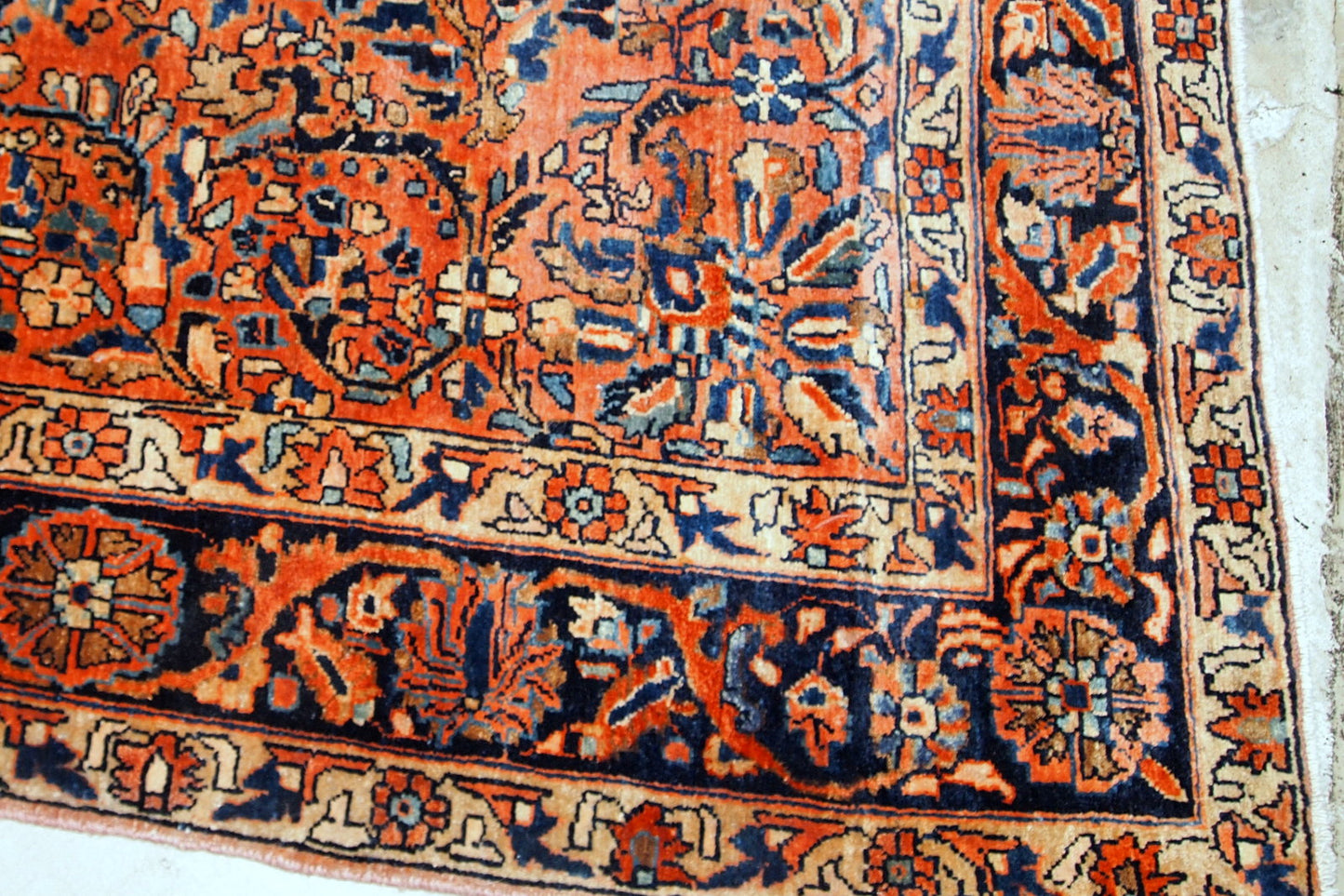 Handmade antique Sarouk rug from the beginning of 20th century. The rug is in original good condition made in red wool.