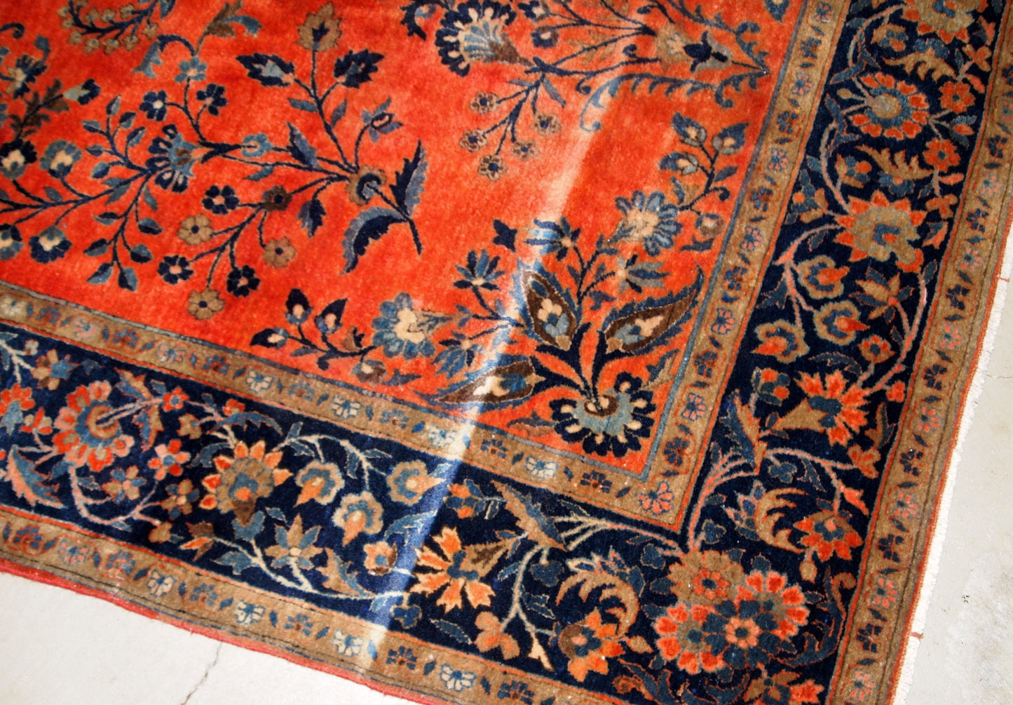 Handmade antique Sarouk rug in original good condition. The rug has been made in the beginning of 20th century in bright red wool.