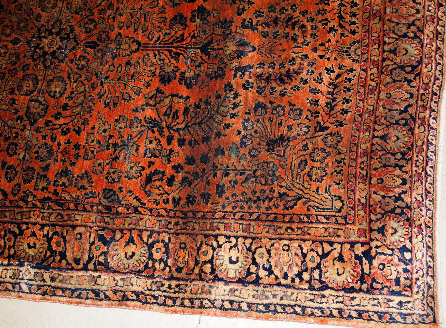 Antique handmade Persian Sarouk rug in original good condition. The rug is from the beginning of 20th century made in red wool.