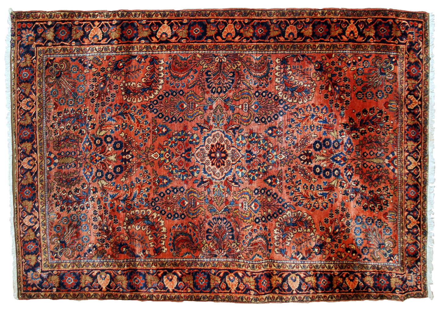 Handmade antique Sarouk rug in original good condition. The rug has been made in the beginning of 20th century in red wool.