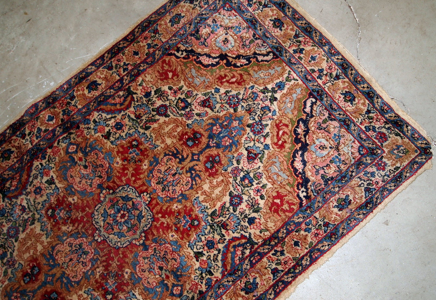 Handmade antique Kerman rug from Middle East in colorful shades. The rug is in original good condition.