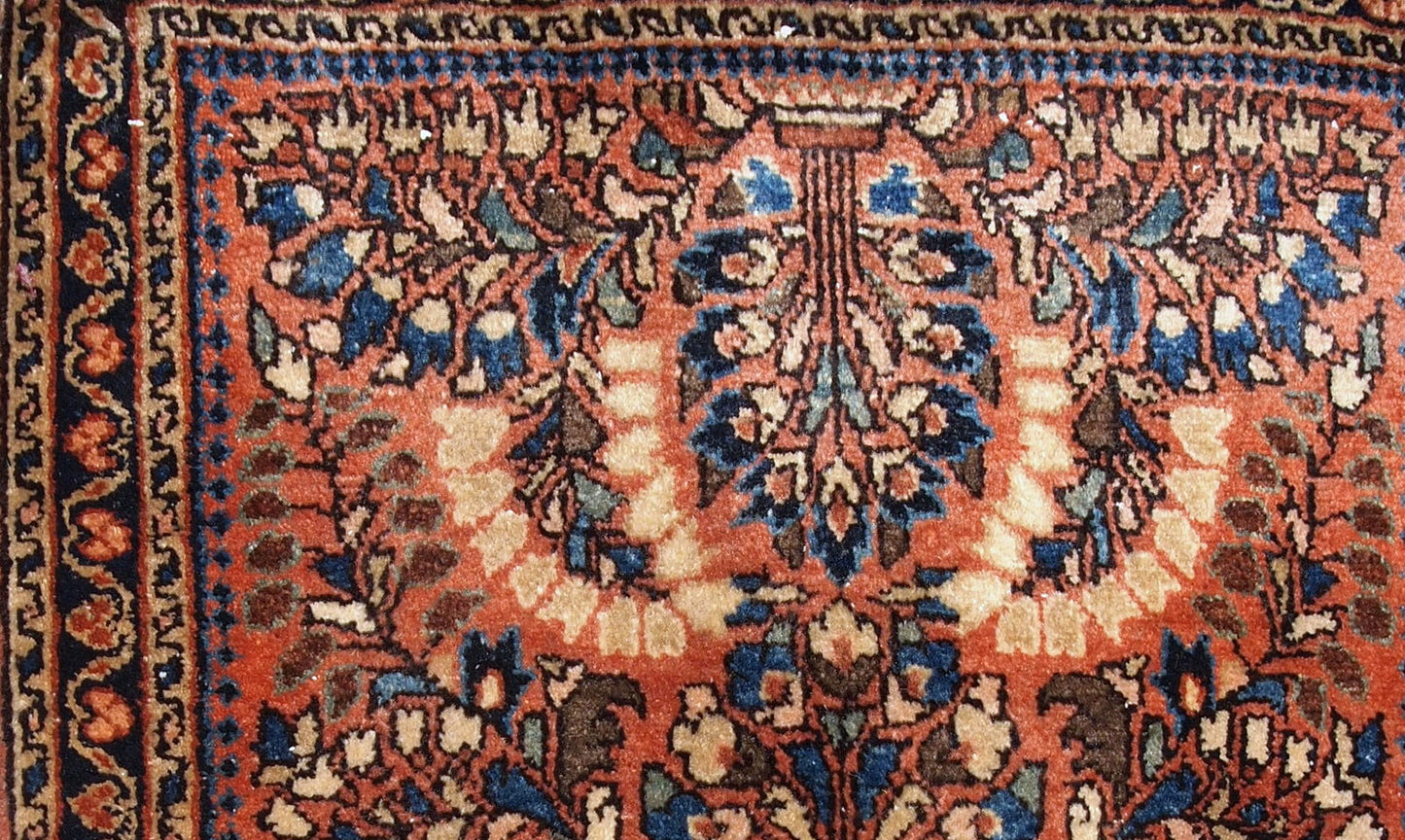 Handmade antique Persian Sarouk rug in original good condition. The rug is from the beginning of 20th century made in traditional design.