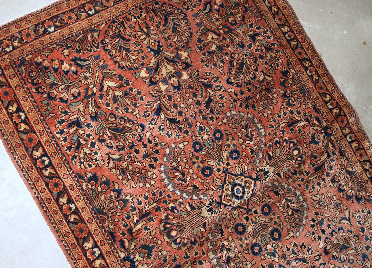 Handmade antique Persian Sarouk rug in original good condition. The rug is from the beginning of 20th century made in traditional design.