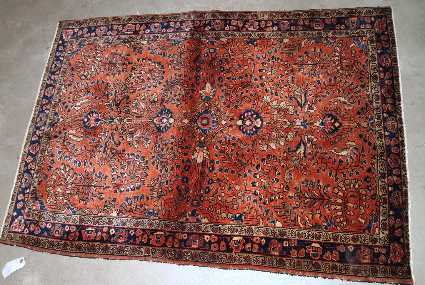 Handmade antique Persian Sarouk rug in original good condition. The rug is from the beginning of 20th century made in bright red wool.