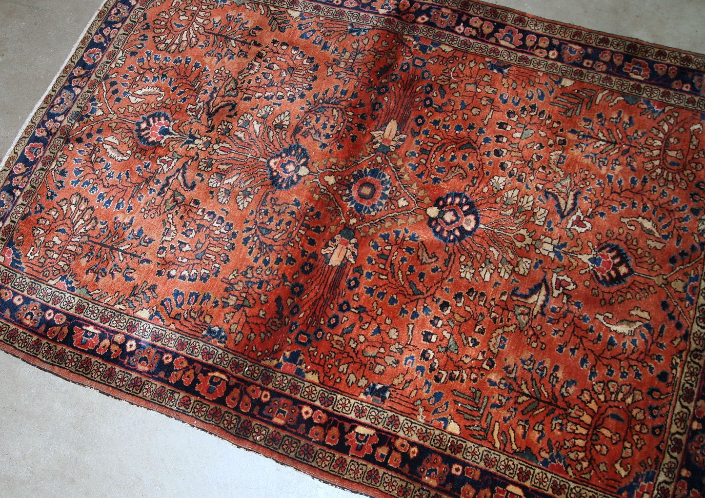 Handmade antique Persian Sarouk rug in original good condition. The rug is from the beginning of 20th century made in bright red wool.
