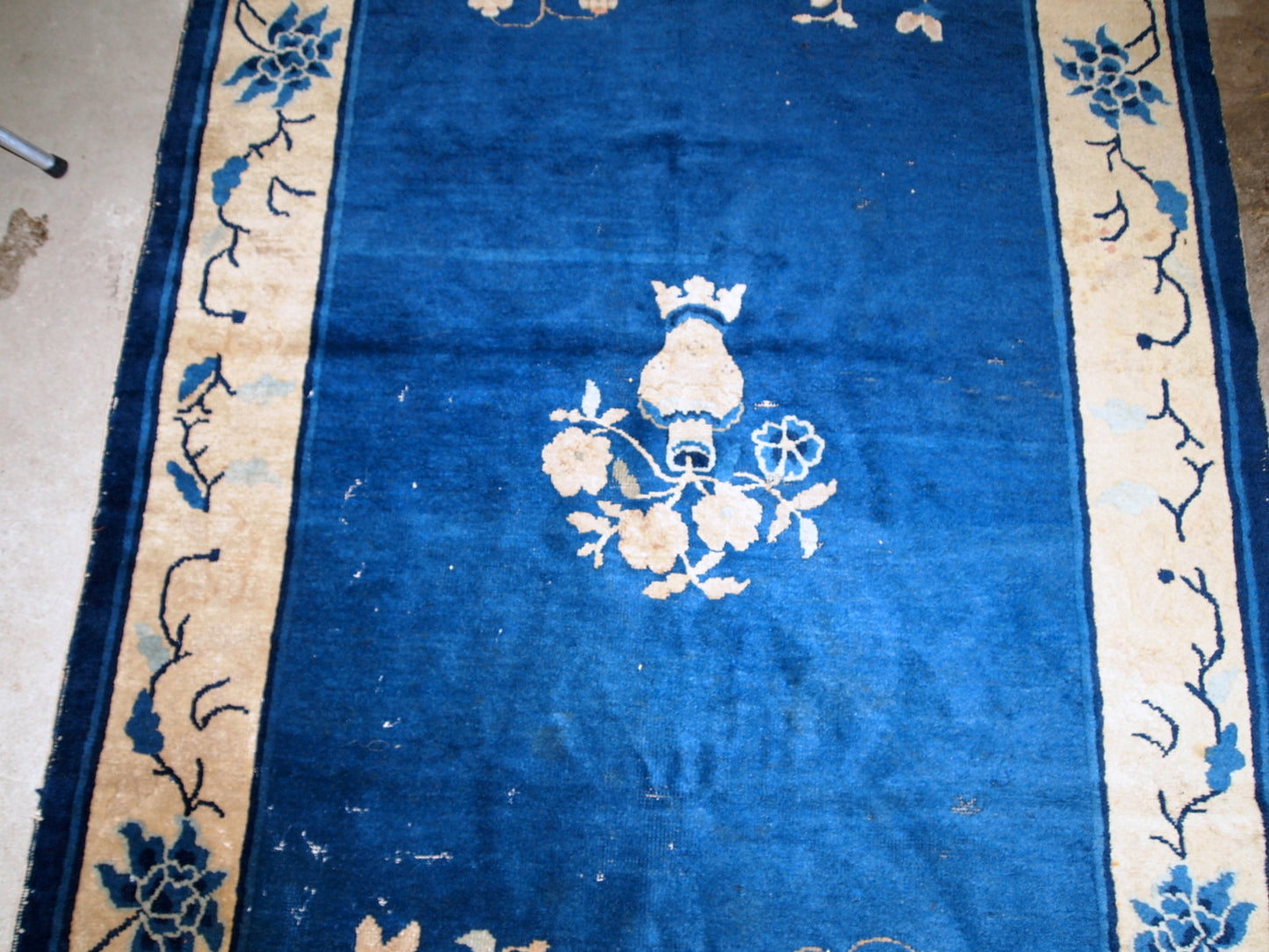 Handmade antique rug from Beijing, China, made in blue wool. The rug is in original condition, has some age wear. It is from the 1900s.