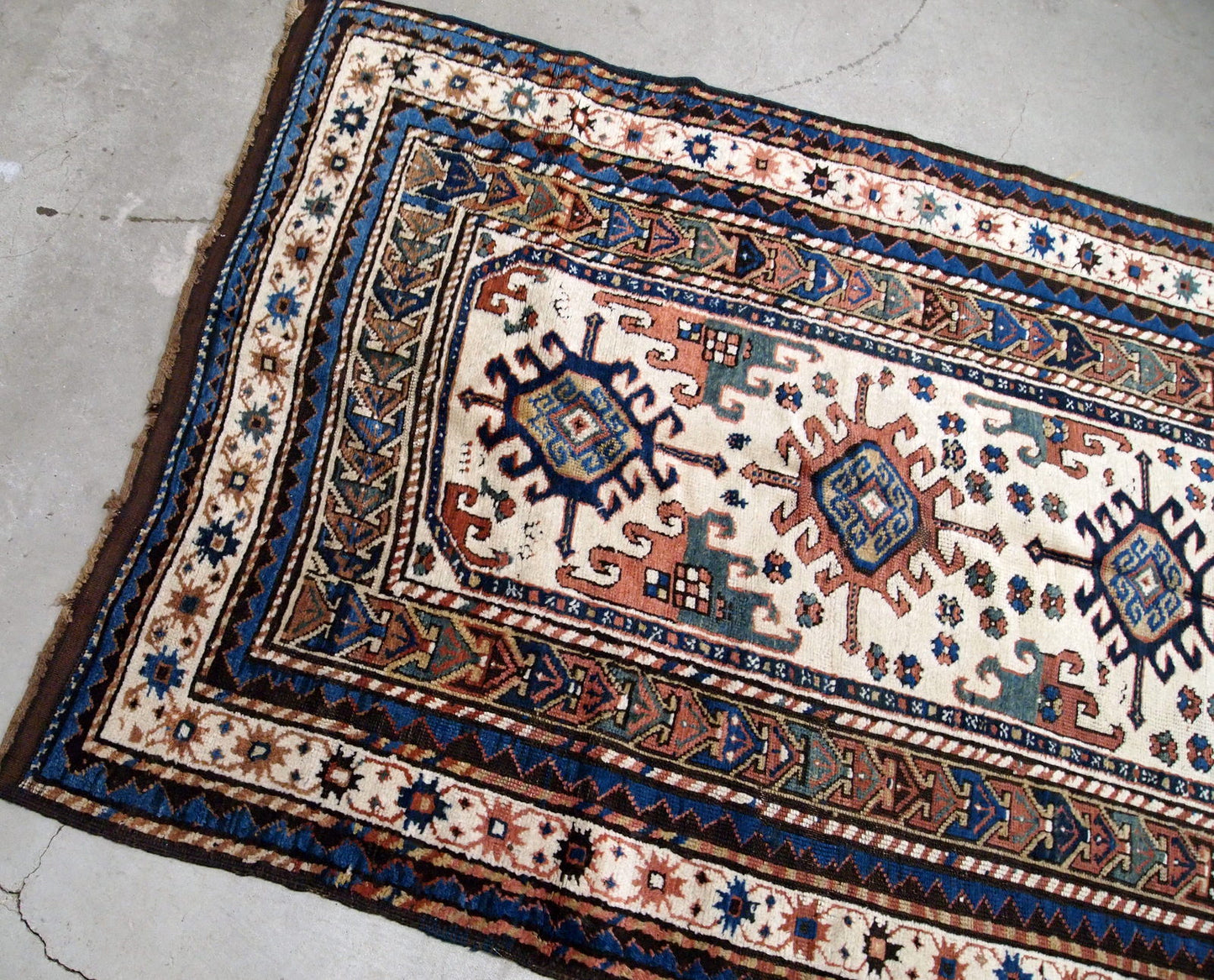 Handmade antique Caucasian Kazak rug in kele size. The rug is from the end of 19th century in original good condition.