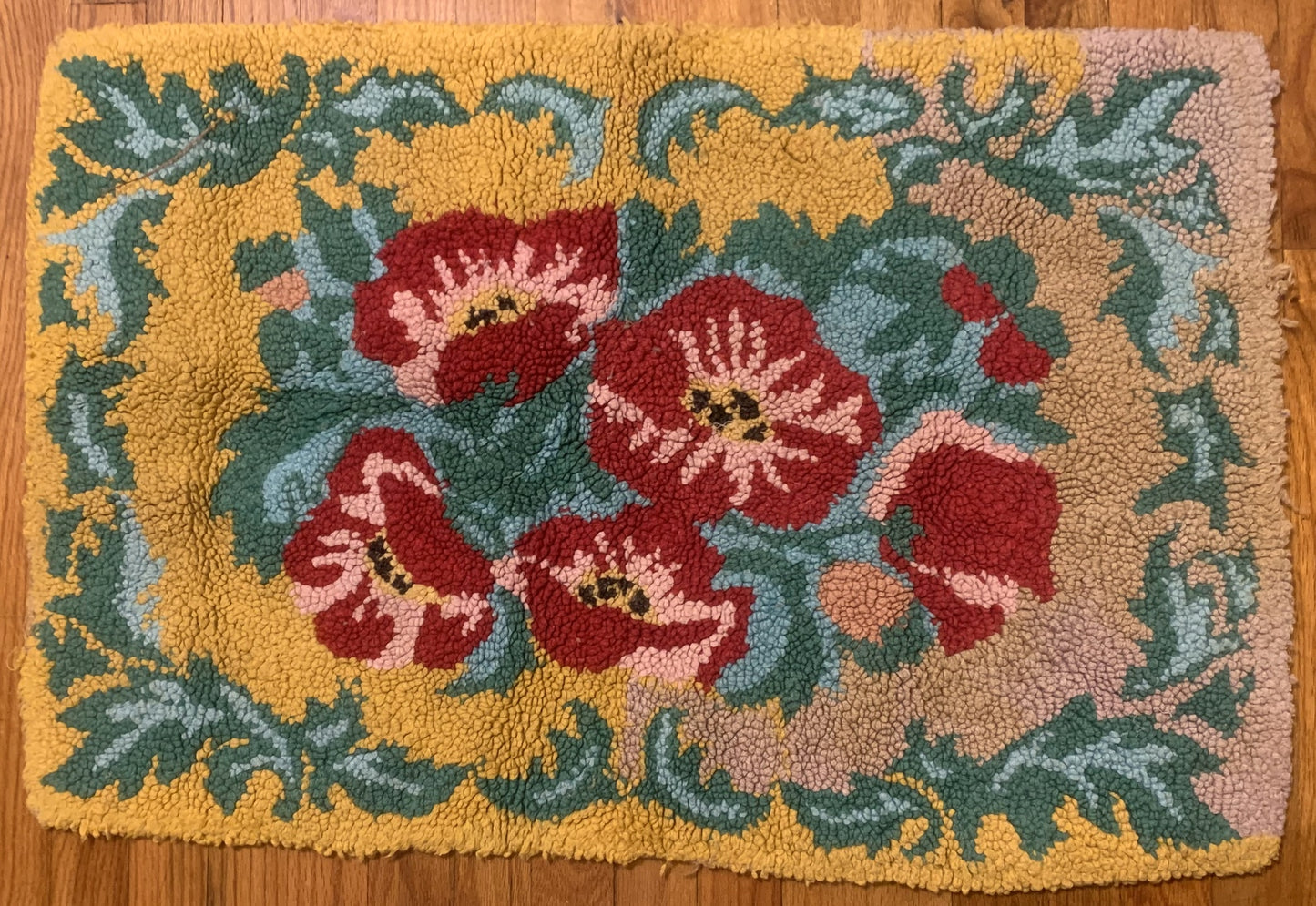 Handmade vintage American Hooked rug in floral design and yellow shade. The rug is from the middle of 20th century in original good condition.