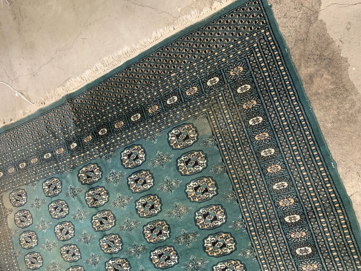 Handmade vintage Uzbek Bukhara rug in Turquoise shade and traditional design. The rug is from the end of 20th century in original condition, it has some age discolorations.
