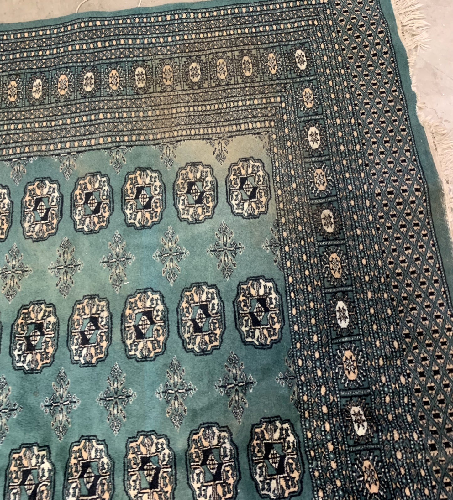 Handmade vintage Uzbek Bukhara rug in Turquoise shade and traditional design. The rug is from the end of 20th century in original condition, it has some age discolorations.