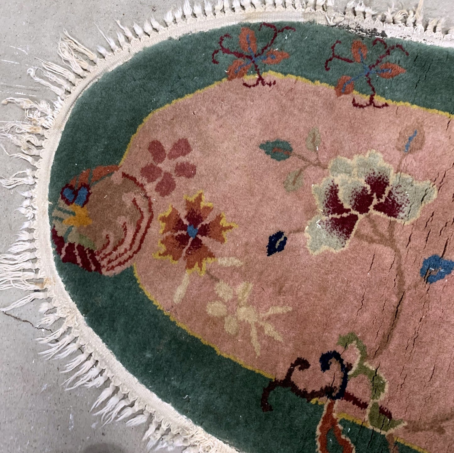 Handmade antique Art Deco Chinese rug in light burgundy and green color. The rug is from the beginning of 20th century in original good condition.