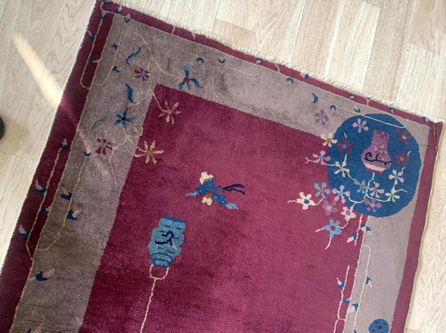 Detailed close-up shots of the handmade antique Chinese rug displaying its intricate patterns, textures, and vintage appeal