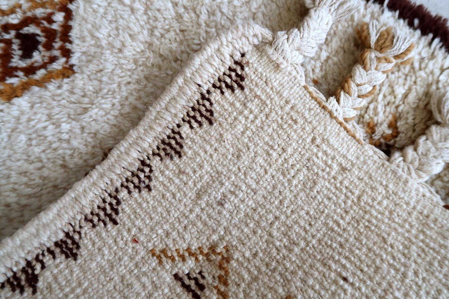 Handmade vintage Moroccan Berber woolen rug in white and brown colors. The rug is from the end of 20th century in original good condition.