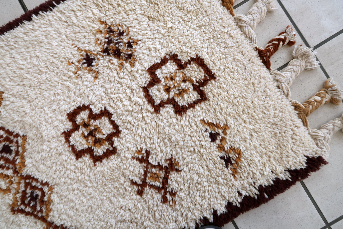 Handmade vintage Moroccan Berber woolen rug in white and brown colors. The rug is from the end of 20th century in original good condition.