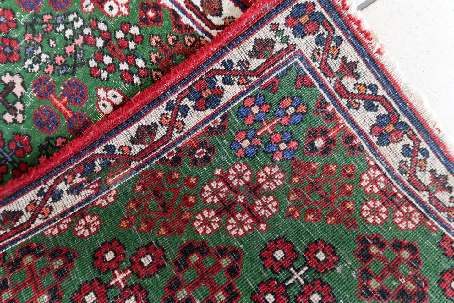 Handmade antique Persian Joshagan runner in green color. The runner is from the beginning of 20th century in original condition, it has some low pile.