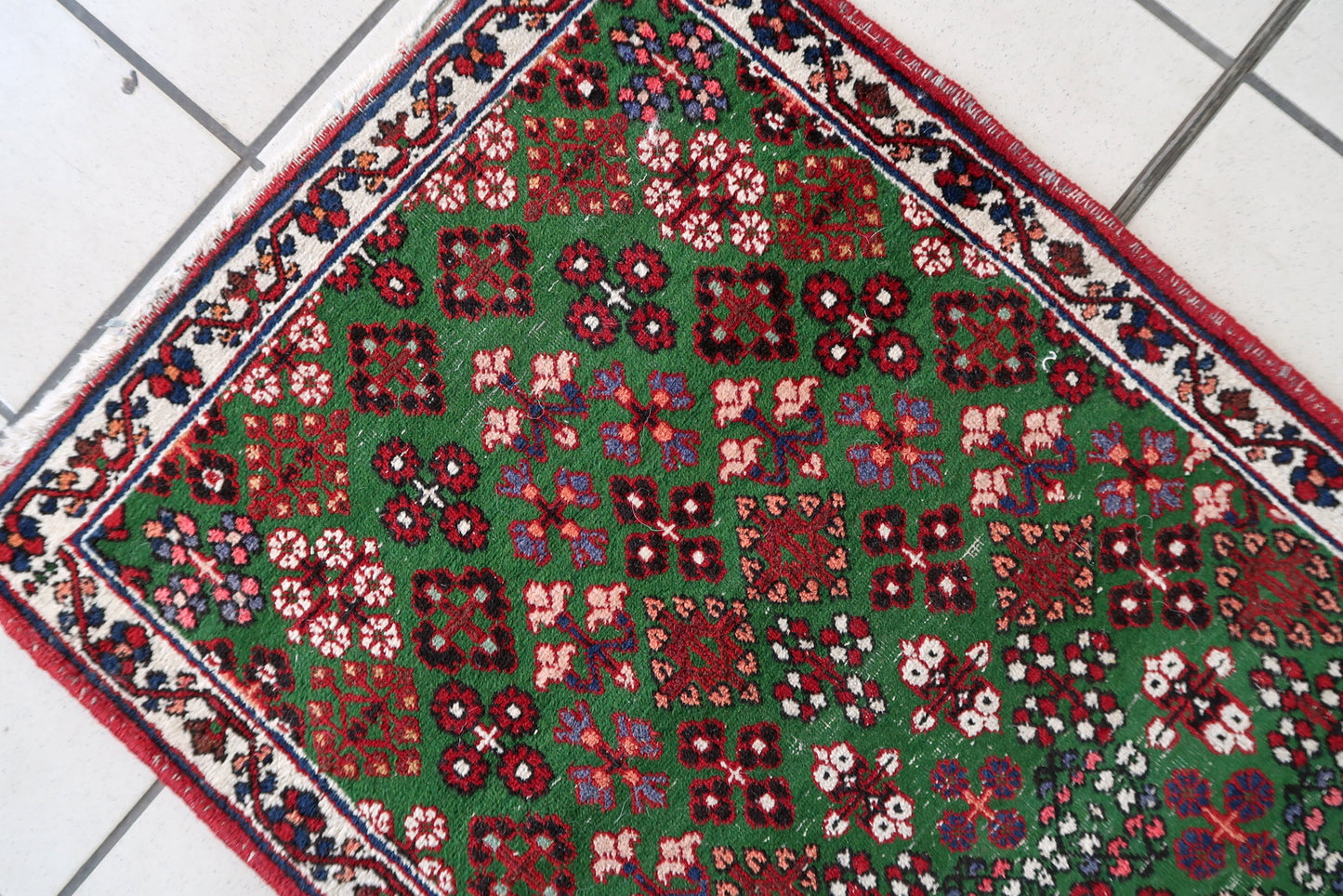 Handmade antique Persian Joshagan runner in green color. The runner is from the beginning of 20th century in original condition, it has some low pile.
