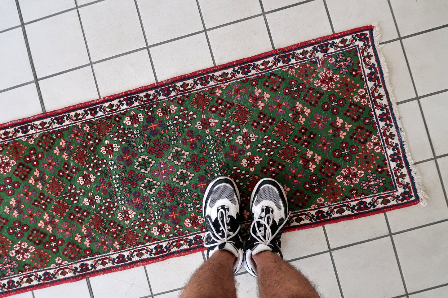Handmade antique Persian Joshagan runner in green color. The runner is from the beginning of 20th century in original condition, it has some low pile.