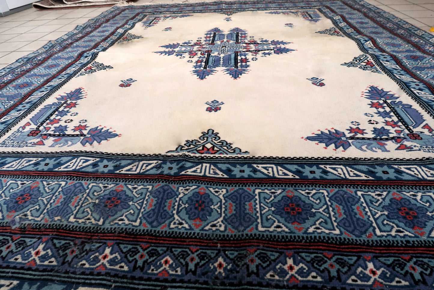 Handmade vintage Tunisian Berber rug in unusual white and blue colors. The rug is from the end of 20th century in original condition, it has some age discolorations.
