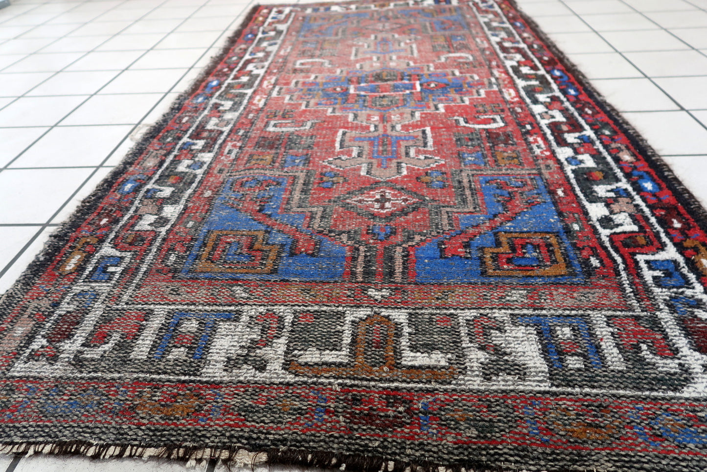 Handmade vintage Persian Hamadan rug in geometric design with large medallion. The rug is from the end of 20th century in distressed condition.