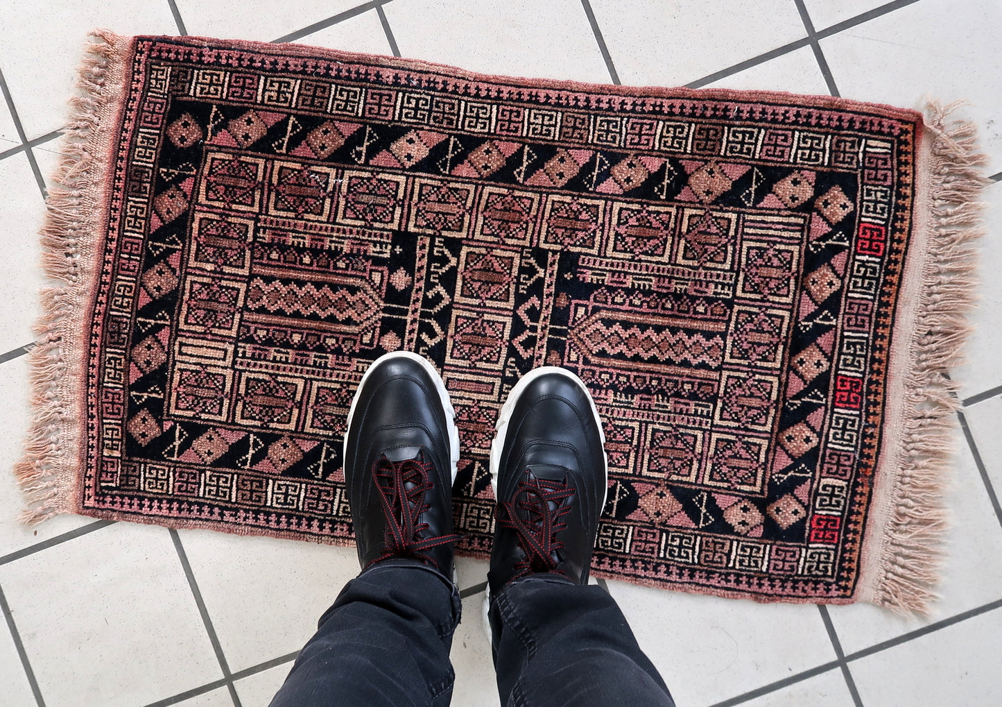 Handmade vintage Afghan Baluch rug in unusual tribal design and beautiful combination of colors. The rug is from the middle of 20th century in original good condition.