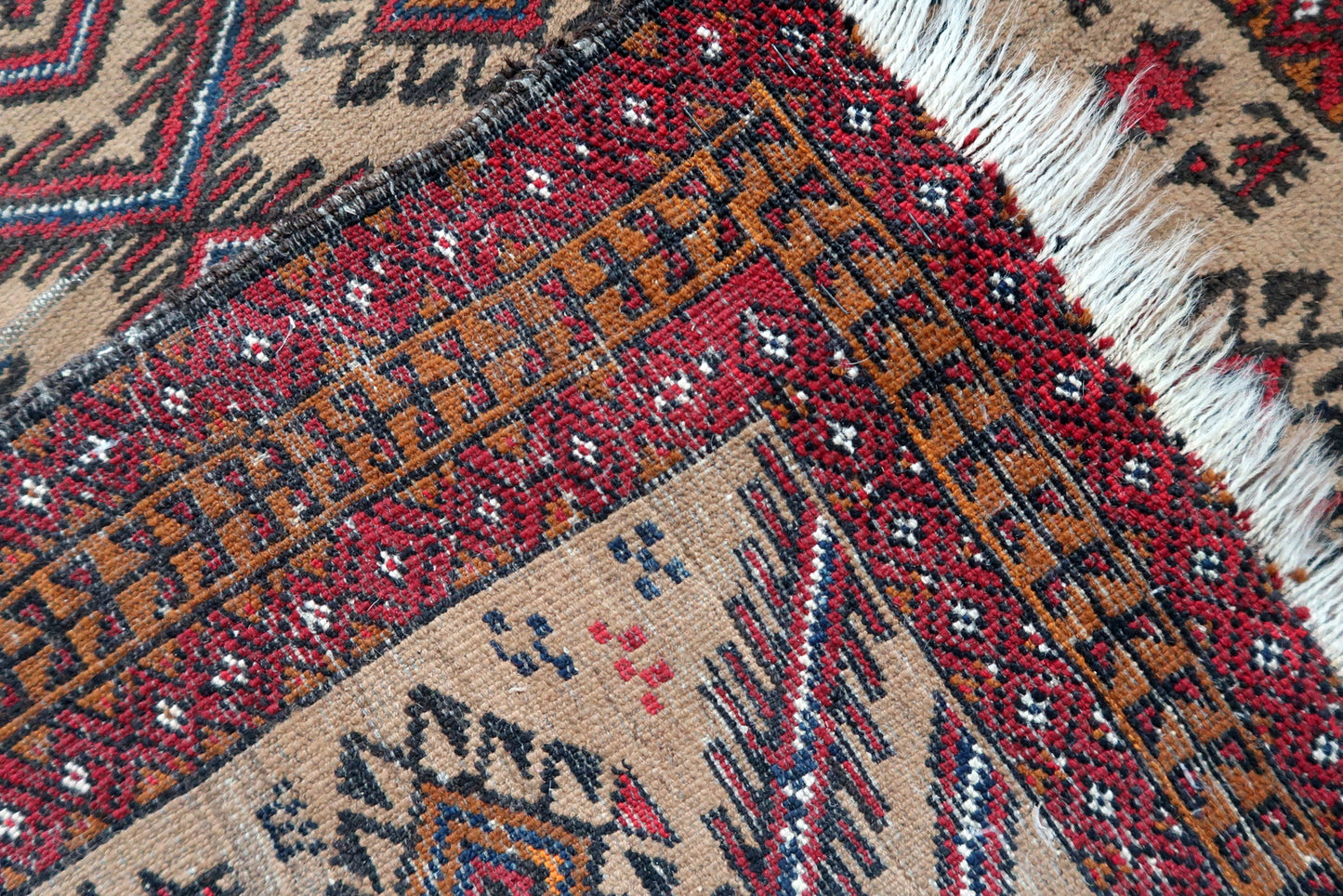 Handmade antique Afghan Baluch rug in tribal prayer design. The rug is from the beginning of 20th century in original condition, it has some low pile.